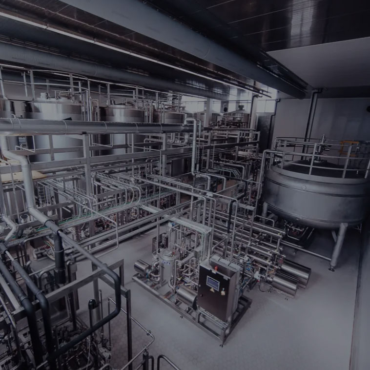 Industrial facility with stainless steel tanks and piping
